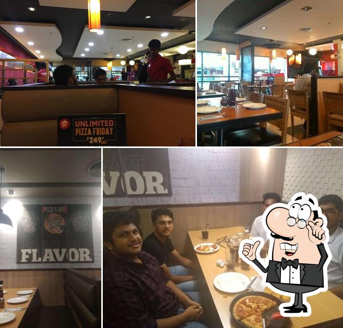 Take a seat at one of the tables at Pizza Hut CMR Cental, Vizag
