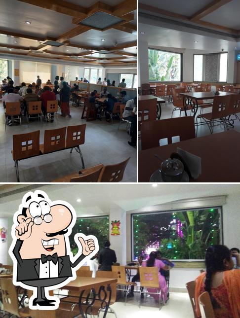 Take a seat at one of the tables at Surguru Restaurant ஸற்குரு உணவகம்