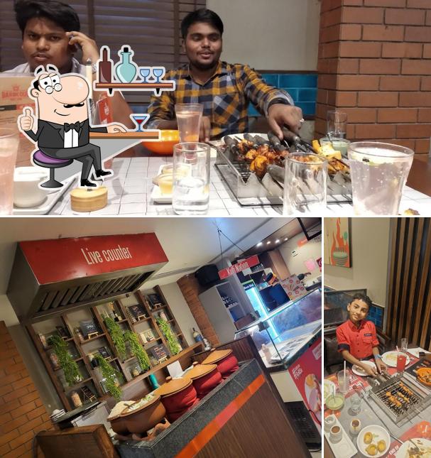 Take a seat at one of the tables at Barbeque Nation - Vellore