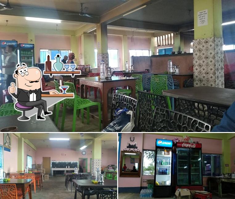 Take a seat at one of the tables at বাগের হোটেল