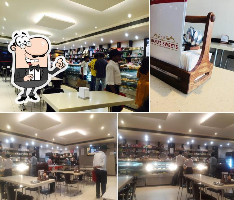 Take a seat at one of the tables at Hanu's Sweets B.D Foods Sweet Shop Namkeen Shop Fast Food Cookies Shop in Panipat