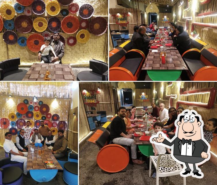 Take a seat at one of the tables at AAOJI KHAOJI RESTAURANT Veg and Nonveg