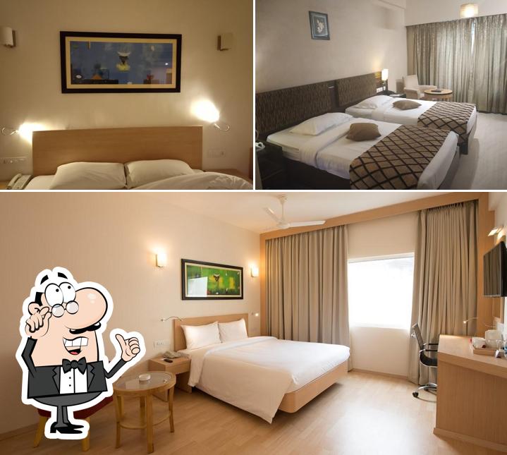 Take a seat at one of the tables at Red Fox by Lemon Tree Hotels, Tiruchirappalli