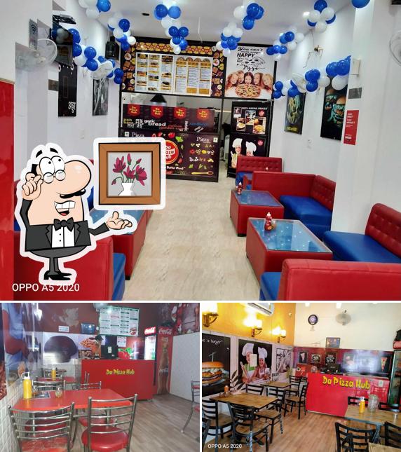 Take a seat at one of the tables at DA PIZZA HUB, JIND