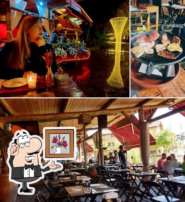 Sente em uma das mesas no Bar e Restaurante Boteco do Lago