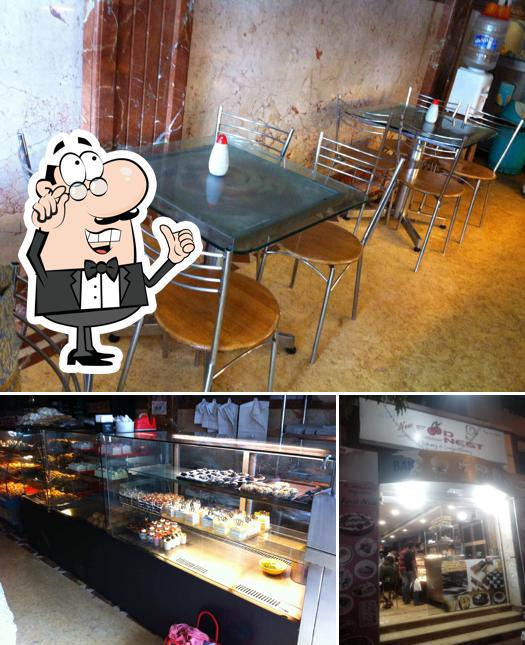 Take a look at the picture displaying interior and food at New Food Nest