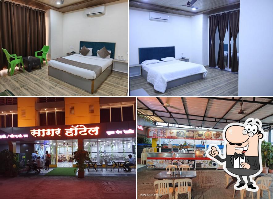 Take a seat at one of the tables at Sagar Hotel Pure Veg Restaurant