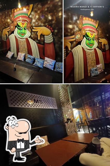 Take a seat at one of the tables at Maawa Mandi & 11 Biryani's