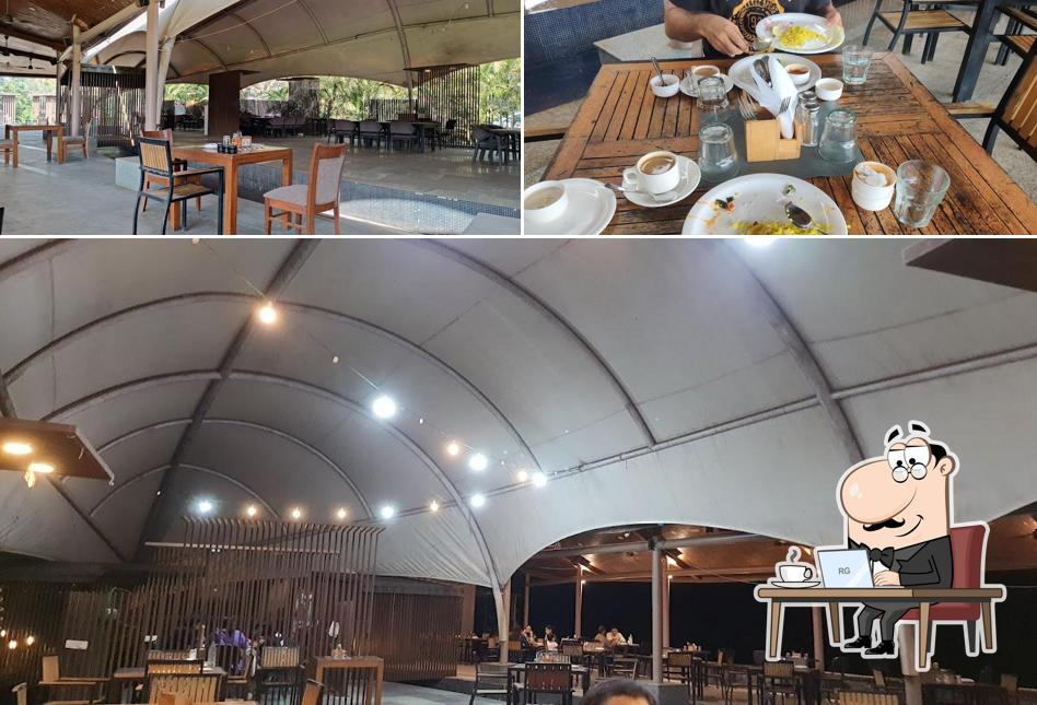 Take a seat at one of the tables at Kharghar Golf Course Pavithra Cafe