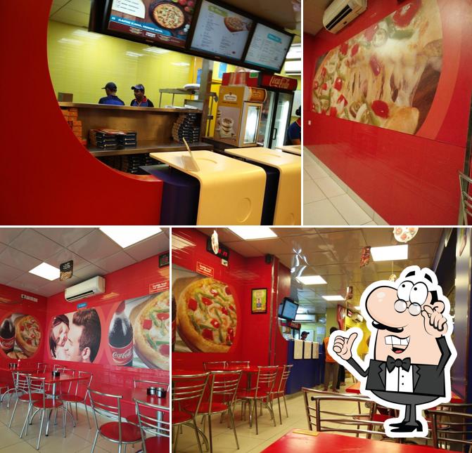 Take a seat at one of the tables at Domino's Pizza Batawadi, Tumakuru