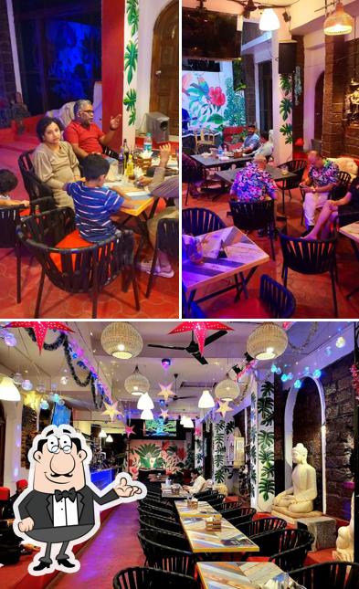 Take a seat at one of the tables at BYOB GOA RESTAURANT & BAR