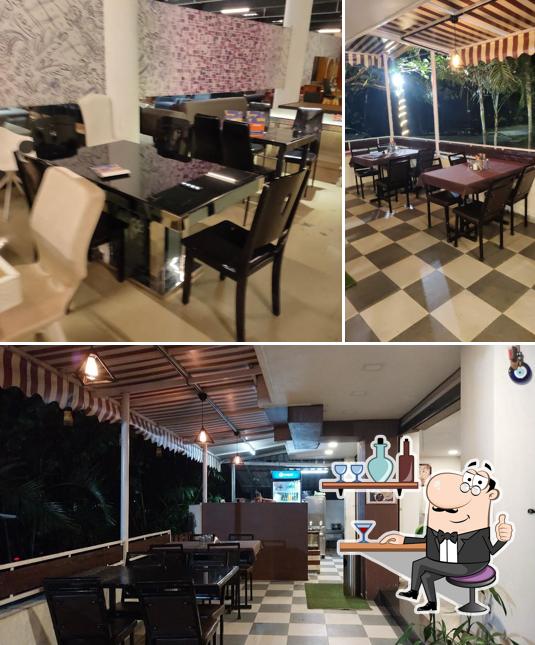 Take a seat at one of the tables at Hotel Kalpataru Oasis