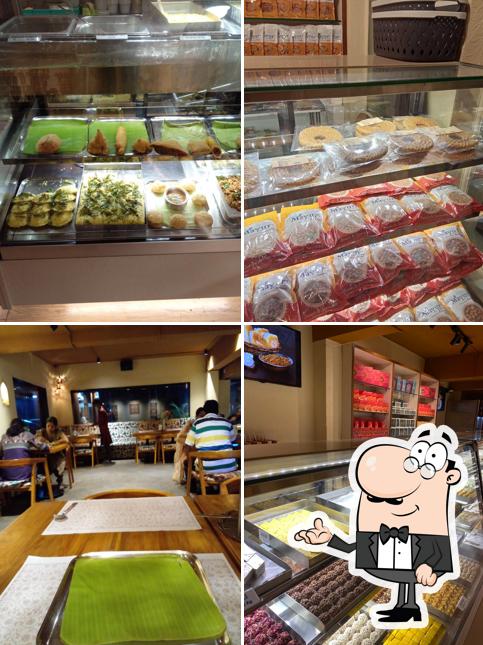 Take a seat at one of the tables at Mayur Sweets, Spices & Cafe (Unit of Annalakshmi SSS)