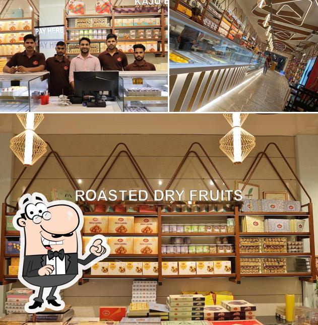 Take a seat at one of the tables at Prakash Sweets & Restaurant