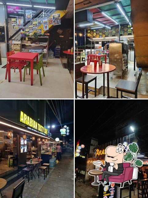 Take a seat at one of the tables at Arabian Tasty Cafe