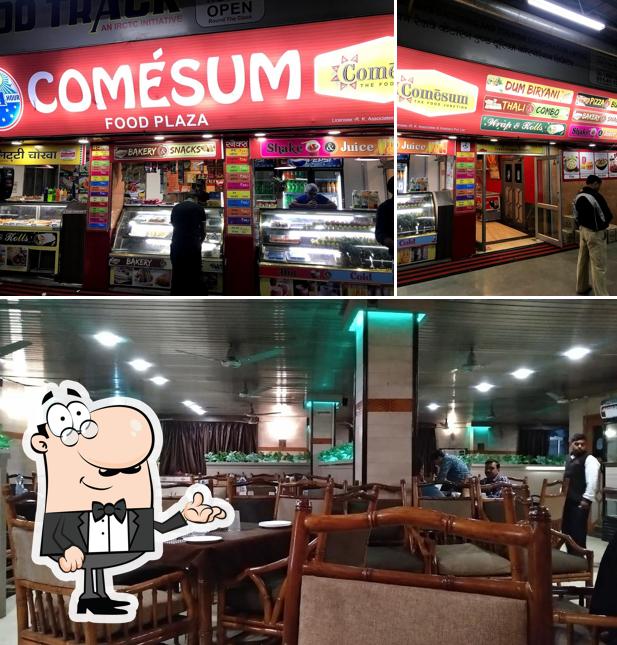 Take a seat at one of the tables at Comesum Food Plaza