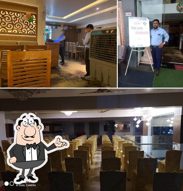 Take a seat at one of the tables at Hotel RadhaKrishna World Of Veg