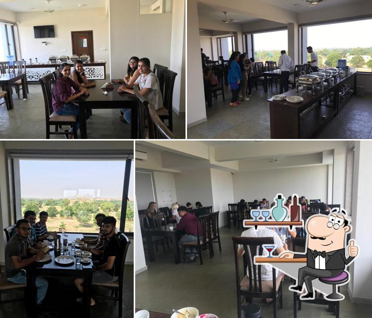 Take a seat at one of the tables at Antra's Kitchen - Palace View & Fort View Multicuisine Restaurant