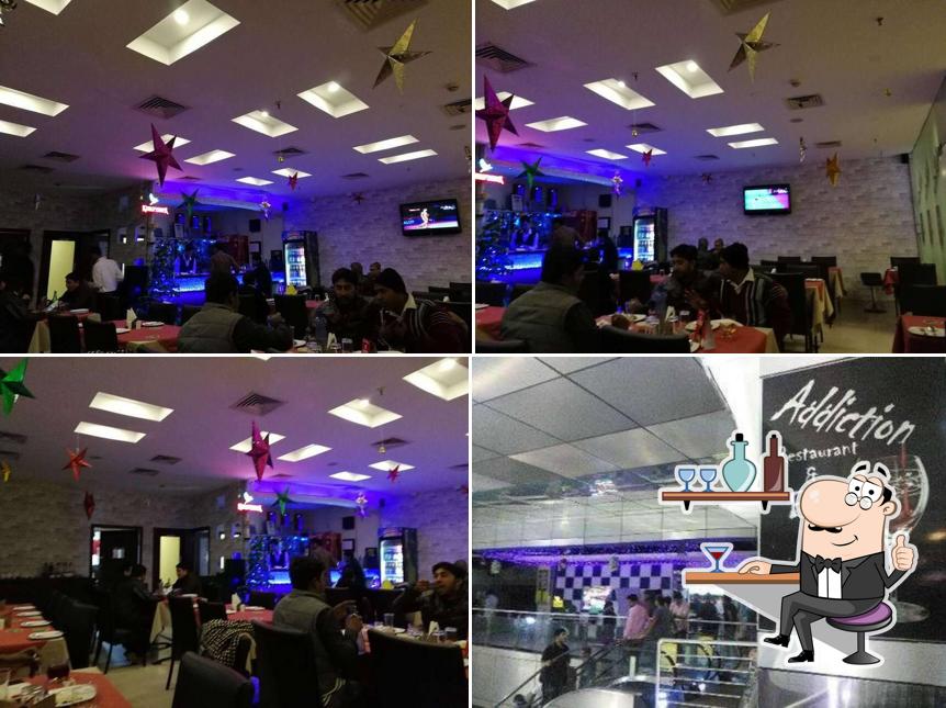 Take a seat at one of the tables at Addiction Bar & Restaurant