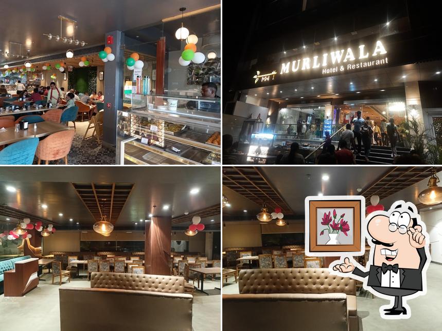 Take a seat at one of the tables at Murliwala Hotel & Restaurant