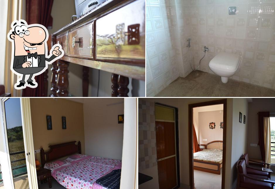 Take a seat at one of the tables at ALIBAG HOLIDAY APARTMENT