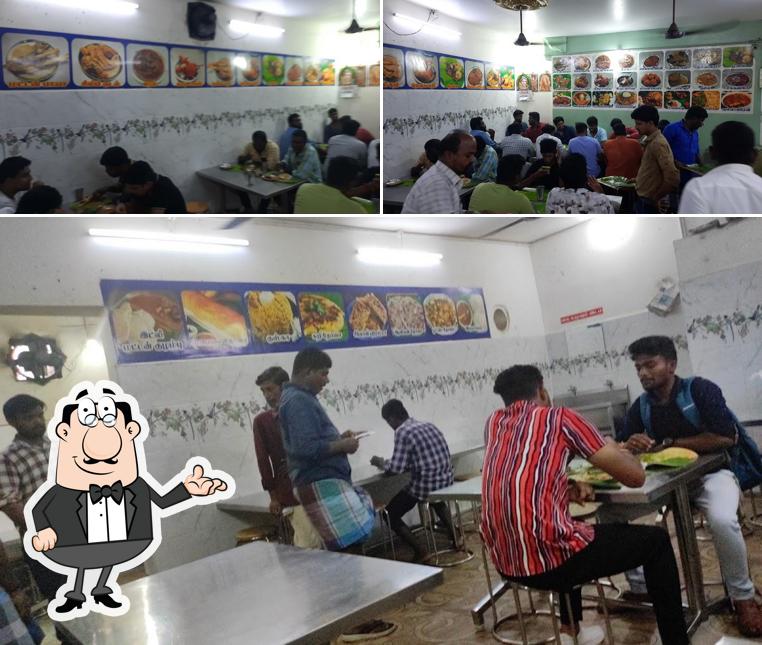 Take a seat at one of the tables at Power Kadai Hotel