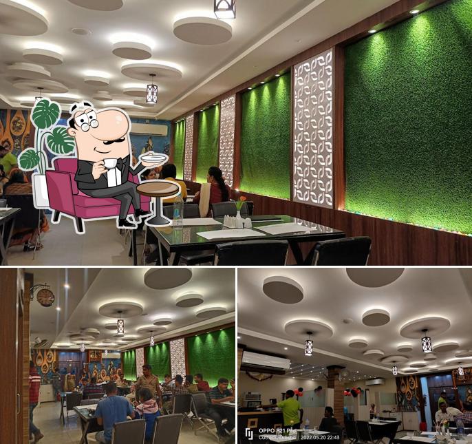 Take a seat at one of the tables at ଫୁଡ୍ ମନ୍ତ୍ରା - Food Mantra Restaurant