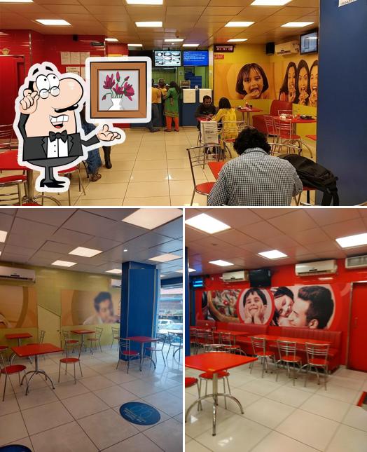 Take a seat at one of the tables at Domino's Pizza Pattom, Thiruvananthapuram