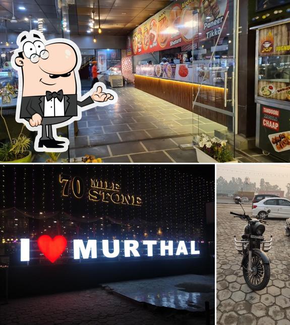 Take a seat at one of the tables at 70 Mile Stone Restaurant & Dhaba