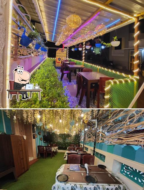 Take a seat at one of the tables at The Lotus Hotel