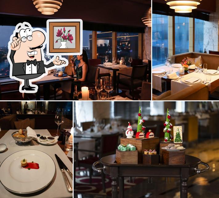 Take a seat at one of the tables at Zanotta - The Leela Ambience Gurugram