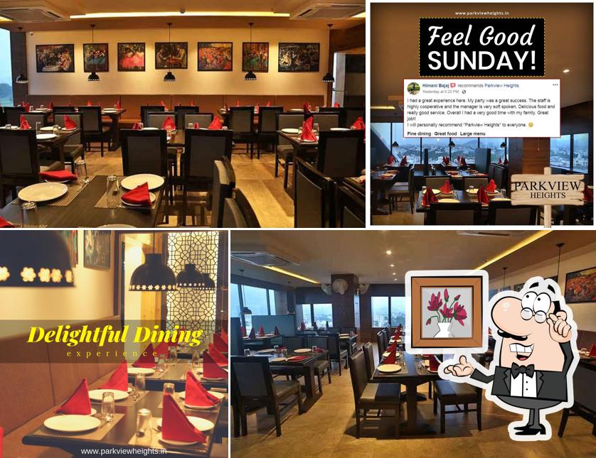 Take a seat at one of the tables at Parkview Heights - Veg & Non Veg Restaurant in Udaipur