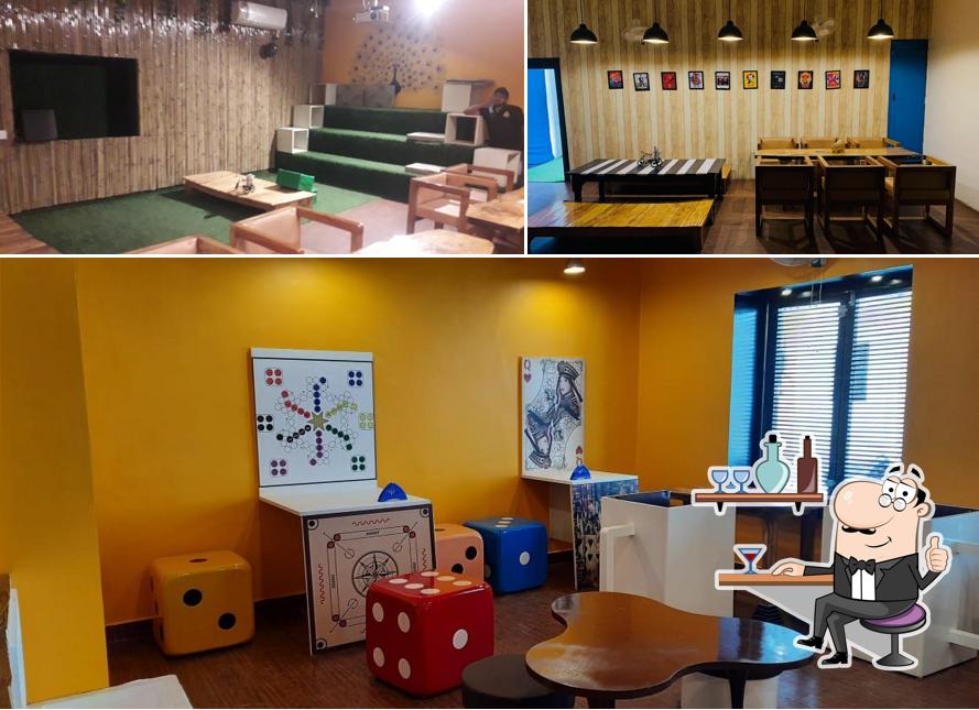 Take a seat at one of the tables at RTS Cafe Aligarh