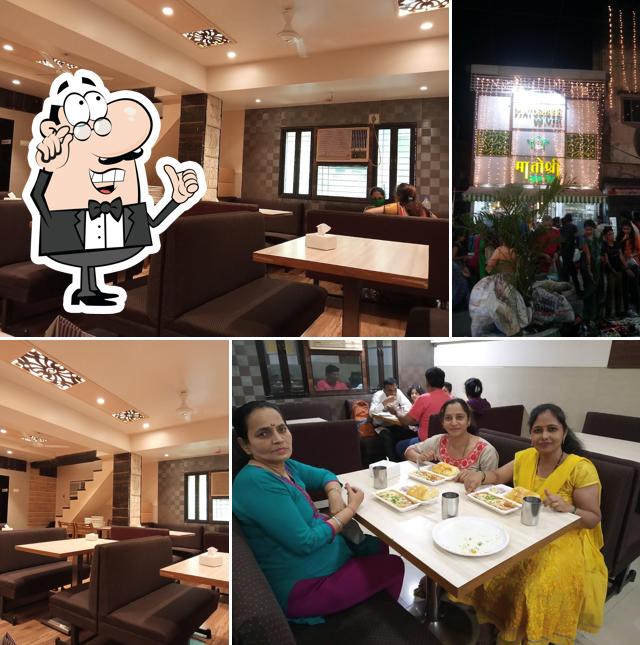 Take a seat at one of the tables at HOTEL MATOSHREE VEG TREAT