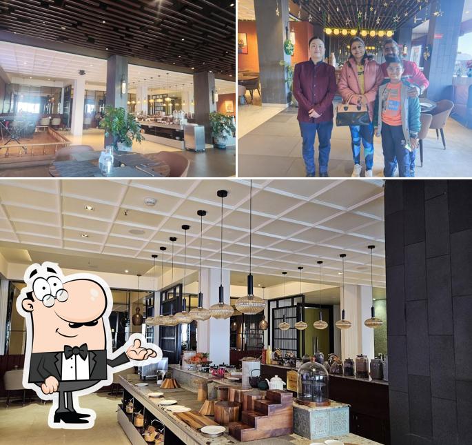 Take a seat at one of the tables at Grains Pure Veg by Udaan Himalayan, Darjeeling