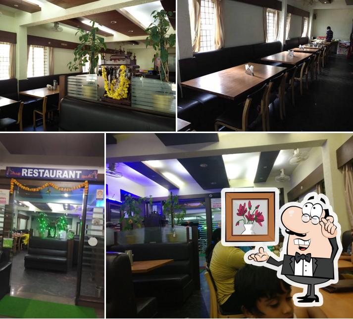 Take a seat at one of the tables at The Grand Mysore Nandhini Andhra Style Family Restaurant