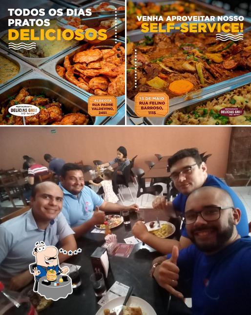 Entre diversos coisas, comida e mesa de jantar podem ser encontrados no Restaurante Delícias Grill