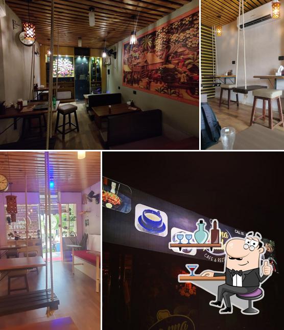 Take a seat at one of the tables at Apna Adda Cafe