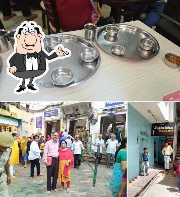 Take a seat at one of the tables at Shree Vallabha Dining Hall (A.C. Hall)