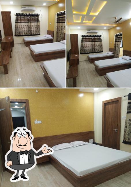 Take a seat at one of the tables at Hotel Laxmi and Restaurant