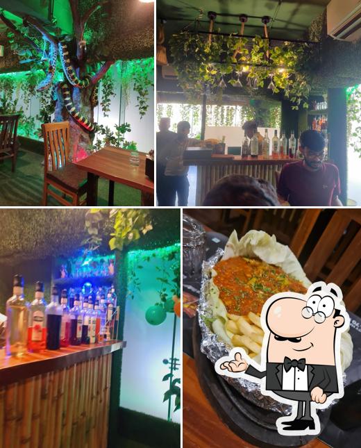 Take a seat at one of the tables at Jungle Cafe & Multicuisine Restaurant