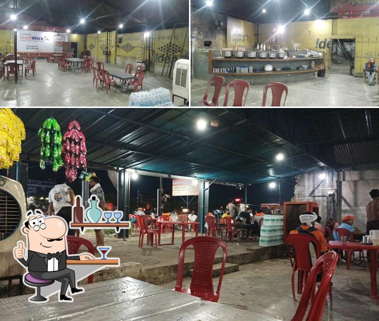 Take a seat at one of the tables at मनजीत पंजाबी तड़का शुद्ध वैष्णो ढाबा