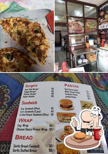 Try out a burger at DOMINE THE PIZZA SHOP