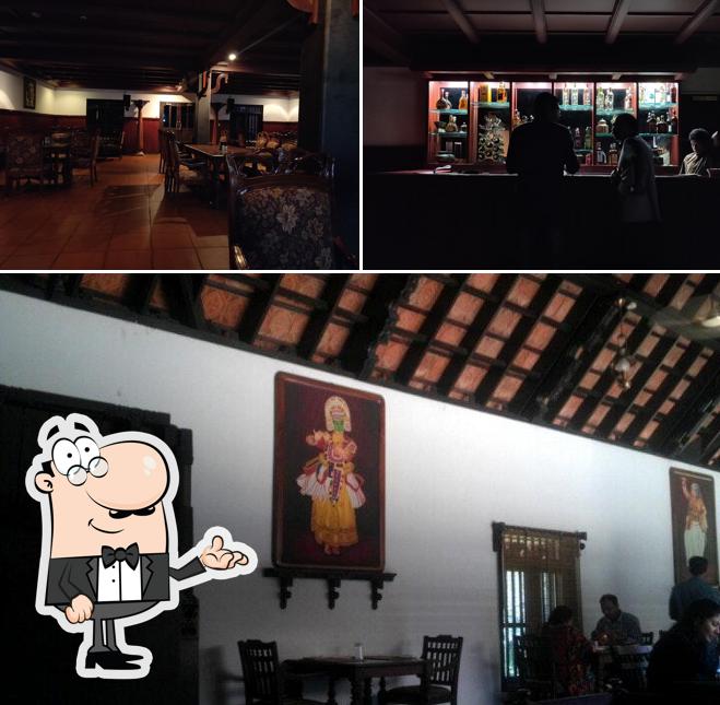 Take a seat at one of the tables at Hotel Travancore Restaurant