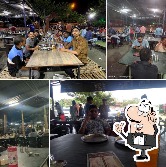 Take a seat at one of the tables at Umiya Annapurna Kathiyawadi Restaurant