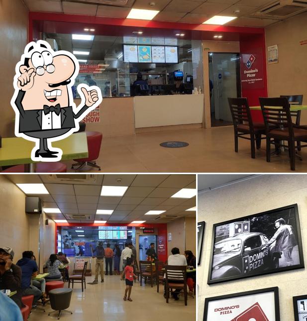 Take a seat at one of the tables at Domino's Pizza Civil Lines, Chandrapur