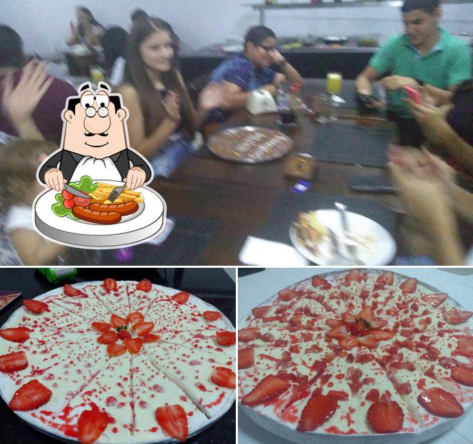 A foto da comida e mesa de jantar no Scarolli Pizzaria - Rodízio com suco e refrigerante Grátis