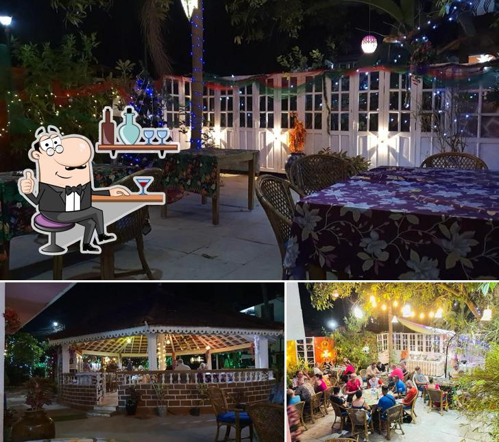 Take a seat at one of the tables at Rosario's Inn (CROWN & ANCHOR) Multicuisine Bar & Restaurant