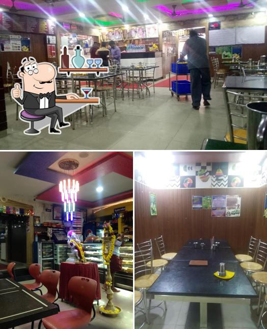 Take a seat at one of the tables at Sri Saravana Bhavan Restaurant