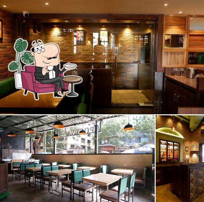 Take a seat at one of the tables at Apoorva Bar and Restaurant